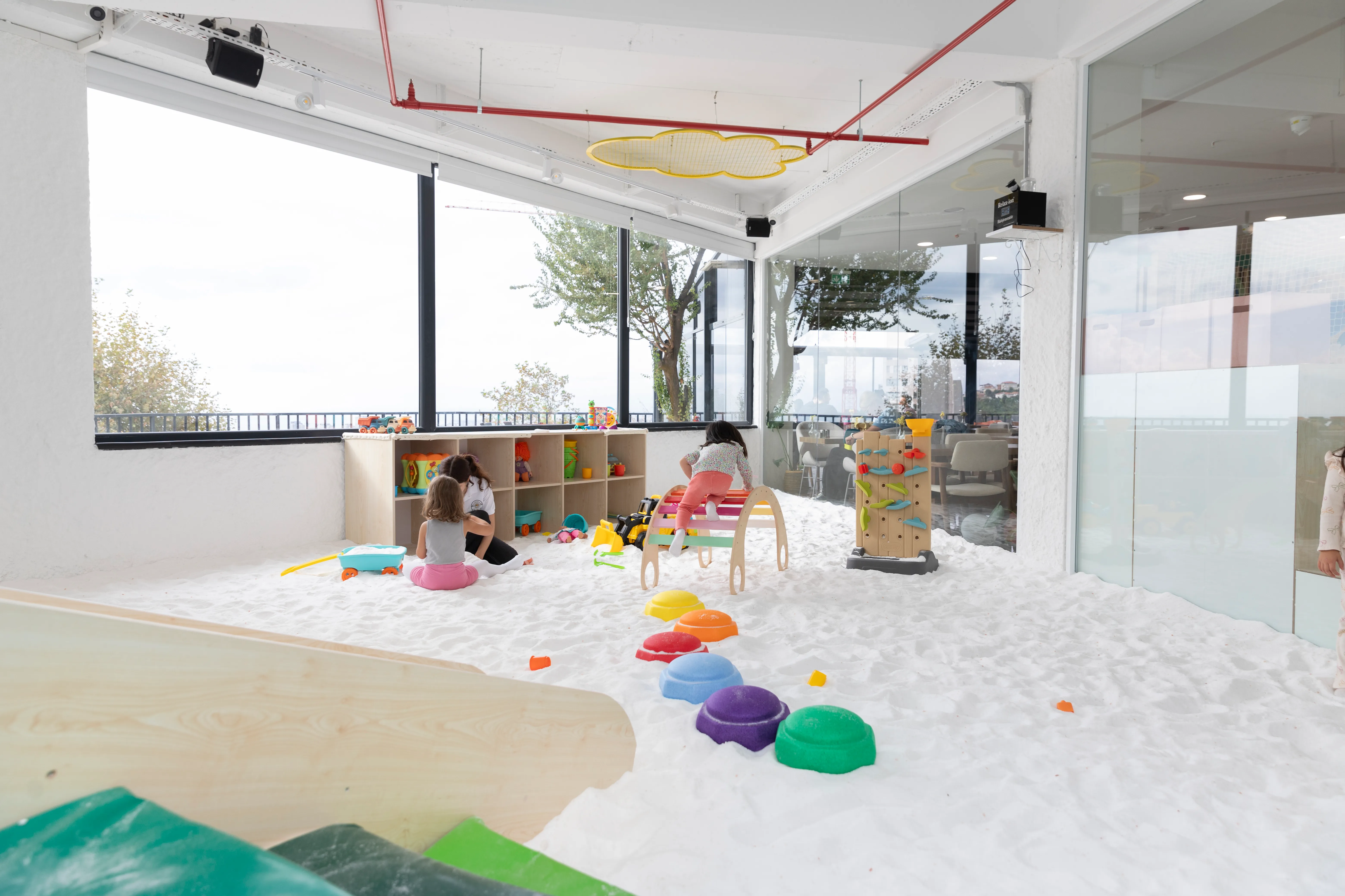 A spacious view of Filifu Cafe’s large salt therapy room, designed for children's play and relaxation.