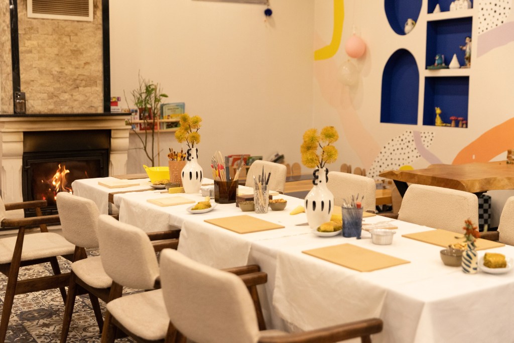 Filifu Cafe’de şömine başında seramik atölyesi için hazırlanmış büyük masa.