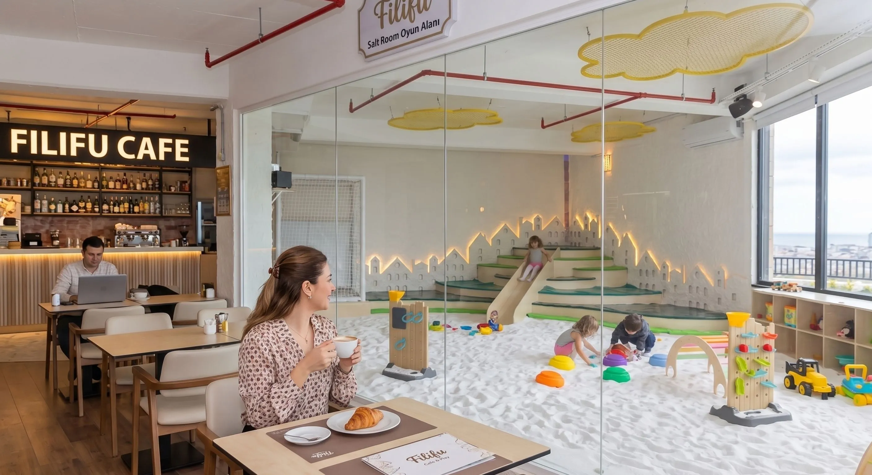Filifu Cafe deniz manzaralı tuz odası çocuk oyun alanı, beyaz tuz zemin, ahşap kaydırak ve gelişimsel oyuncaklar.